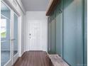 Well-lit entryway with coat hooks, bench, and stylish flooring, offering a practical and welcoming space at 18189 House Finch Ln, Parker, CO 80134