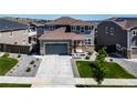 Beautiful two-story home with a well-kept lawn, showcasing a blend of modern design and comfortable living at 18189 House Finch Ln, Parker, CO 80134
