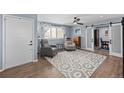 Stylish living room featuring hardwood floors, a patterned rug, and plenty of natural light at 1246 S Routt Way, Lakewood, CO 80232