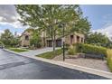 Attractive multi-story townhome with brick and stucco exterior, two-car garage and landscaping at 3491 Cascina Pl # D, Highlands Ranch, CO 80126