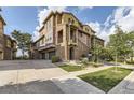 Lovely multi-story townhome with brick and stucco facade, two-car garage and professional landscaping at 3491 Cascina Pl # D, Highlands Ranch, CO 80126