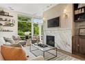 Bright living room with a marble fireplace, large windows, and stylish decor at 3220 Zuni St, Denver, CO 80211