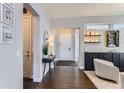 Bright and airy entryway with a built-in bar and hardwood floors at 9724 Cantabria Pt, Lone Tree, CO 80124