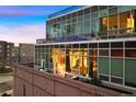 Exterior view of modern condo with glass facade and brick base at 1143 Auraria Pkwy # 402, Denver, CO 80204