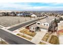An aerial view of a beautiful two-story home on a landscaped lot in a suburban neighborhood at 15753 E Indian Brook Cir, Parker, CO 80134