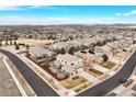 An aerial view showcases a lovely neighborhood with well-maintained homes and tree-lined streets at 15753 E Indian Brook Cir, Parker, CO 80134