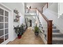 Elegant foyer with high ceilings, tiled floor, staircase, and decorative accents at 15753 E Indian Brook Cir, Parker, CO 80134