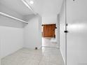 View of the entryway with tile floors and wood paneling in the next room at 9700 E Iliff Ave # D44, Denver, CO 80231