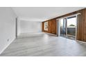 Spacious living room featuring wood paneled accent wall and sliding glass doors at 9700 E Iliff Ave # D44, Denver, CO 80231