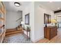 Open entryway with hardwood floors, staircase, decorative rug and modern decor at 1321 W Caley Ave, Littleton, CO 80120