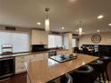 Modern kitchen with granite countertops and white cabinetry at 7870 S Ogden Way, Centennial, CO 80122