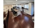 Spacious kitchen featuring an island, stainless steel appliances, and hardwood floors at 7870 S Ogden Way, Centennial, CO 80122