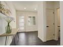 Bright entryway featuring hardwood floors, modern console table, and lots of natural light at 14077 Yellow Tip Drive, Parker, CO 80134