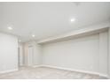 Spacious basement with neutral carpet and lighting, ideal for customization at 2858 W Parkside Pl, Denver, CO 80221