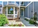 Cozy front porch area with a bench and chairs, stone accents, and inviting entrance at 9682 Hemlock Ct, Highlands Ranch, CO 80130