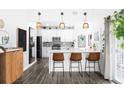 Well-lit kitchen featuring modern white cabinets, stainless appliances, and a sleek breakfast bar at 13706 Legend Trail # 104, Broomfield, CO 80023