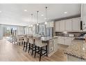Bright eat-in kitchen featuring granite counters, a kitchen island with bar seating, and stainless appliances at 18036 E 99Th Ave, Commerce City, CO 80022
