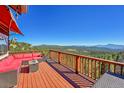 Relax on the large deck with comfortable outdoor seating and take in the breathtaking mountain views at 31324 Kings Vly, Conifer, CO 80433