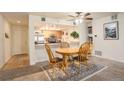 Cozy dining area adjacent to the kitchen with a wooden table set and a ceiling fan at 23634 Pondview Pl # B, Golden, CO 80401