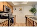 Bright kitchen with stainless steel appliances, granite countertops, and light wood cabinetry at 23634 Pondview Pl # B, Golden, CO 80401