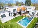 Aerial view of a modern home, pool, patio, and outdoor dining area at 1 S Forest St, Denver, CO 80246