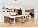 Elegant kitchen boasting a large island, modern appliances, and stylish pendant lighting at 1 S Forest St, Denver, CO 80246