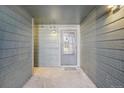 Exterior condo entryway with grey walls and a door at 14190 E Temple Dr # O-04, Aurora, CO 80015