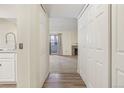 View down condo hallway with doors to bedrooms and living room at 14190 E Temple Dr # O-04, Aurora, CO 80015