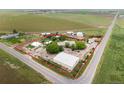 Aerial view showcases the property's boundaries, surrounding fields, and multiple structures on the land at 20995 County Road 28, Hudson, CO 80642