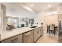 Open-concept kitchen with stainless steel appliances and views into the living room and dining area at 14602 E 2Nd Ave # 200C, Aurora, CO 80011