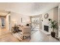 Bright living room featuring a fireplace, sliding glass doors to the outside, and neutral decor at 14602 E 2Nd Ave # 200C, Aurora, CO 80011