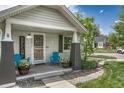Inviting front porch with cozy blue chairs, potted plants, and a 'Welcome' sign at 3201 S Pearl St, Englewood, CO 80113