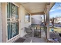 Inviting front porch with seating area, providing a cozy outdoor space to relax and enjoy the neighborhood views at 1214 S Akron Way, Denver, CO 80247