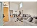 Bright living room with soaring ceilings, large windows, chandelier, and an open floorplan layout at 1214 S Akron Way, Denver, CO 80247
