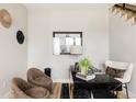 A modern home office space featuring two comfortable chairs and a sleek black desk with gold accents, ideal for productivity at 8280 E 36Th Ave # 27, Denver, CO 80238