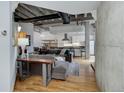 Open-concept living room with exposed ductwork, hardwood floors, and modern furnishings at 1020 15Th St # 210, Denver, CO 80202