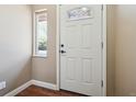 Bright entryway featuring a white front door with decorative glass and a sidelight window at 13895 W Atlantic Ave, Lakewood, CO 80228