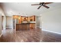 Open-concept kitchen with a center island, stainless steel appliances, and hardwood floors at 13895 W Atlantic Ave, Lakewood, CO 80228