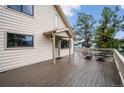 Exterior view of a large stained wood deck with an outdoor seating arrangement at 9189 Fallen Rock Rd, Conifer, CO 80433