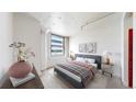 Serene bedroom showcasing a comfortable bed, city views from large windows, and stylish decor at 444 17Th St # 301, Denver, CO 80202
