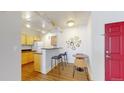 Modern kitchen with a breakfast bar, sleek countertops, and ample cabinet space next to a cozy dining area at 444 17Th St # 301, Denver, CO 80202