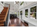 Light-filled living room features hardwood floors, fireplace, staircase, and large windows at 1010 Euclid Ave, Boulder, CO 80302