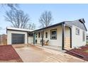 Charming single-story home with a covered porch and an attached garage at 3067 Robin Way, Denver, CO 80222