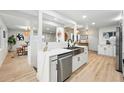 Modern kitchen featuring stainless steel appliances, a sleek sink, and ample counter space at 3067 Robin Way, Denver, CO 80222