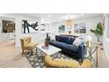 Open-concept living room with plenty of natural light and modern decor at 3067 Robin Way, Denver, CO 80222