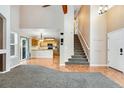 Open-concept entryway features high ceilings, stairs to the upper level and adjoins a kitchen and dining area at 12535 Forest View St, Broomfield, CO 80020