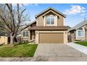 Charming two-story house featuring a spacious driveway and attached garage, surrounded by a lush green lawn at 12535 Forest View St, Broomfield, CO 80020