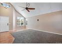 Spacious living room with vaulted ceilings and large windows allowing ample natural light at 12535 Forest View St, Broomfield, CO 80020