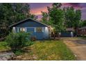 Charming single-story home featuring a lush green lawn, mature trees, and a private driveway with a detached garage at 362 Brigitte Dr, Northglenn, CO 80260