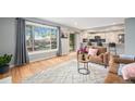Open-concept living room flows to the backyard with views of the modern kitchen at 362 Brigitte Dr, Northglenn, CO 80260